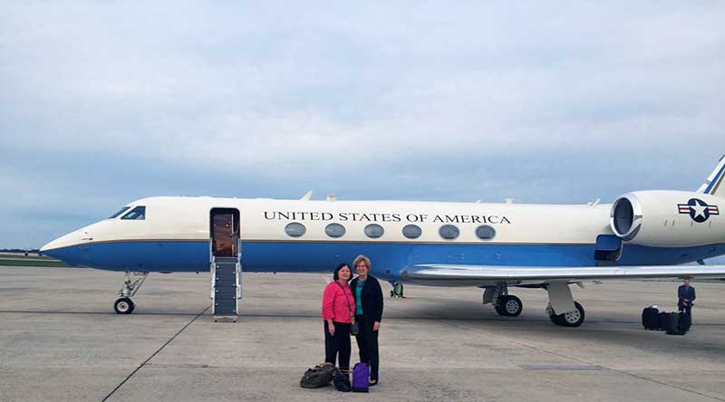 Carolyn Woo (left), President of Catholic Relief Services, and Sister Donna Markham, OP, wait to board a military jet for Rome to attend the Canonization of Mother Teresa.