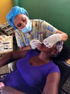 Doctor Fabiola Reyes works on a patient during a free dental clinic in the Dominican Republic. An Associate, Dr. Reyes coordinated the clinic, which was sponsored by the Associate Group Antorcha. 
