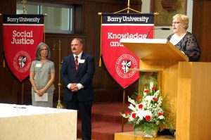 Carmen McCrink and Michael Provitera, new Adrian Dominican Associates from Barry University, listen as Mary Lach, Director of Associate Life, leads the November 14 Rite of Acceptance. (Photo by Thierry Lach)